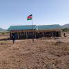 High school classrooms by govt.  We provided solar panels and lighting and desks for students. Flag pole and flag.