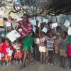 Students at Kulol asking for shelter.  They are holding up papers saying we are the Kulol Primary School  Just have kindergarten and grade 1.