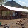 Completed shelter.  Metal wall in middle making 2 rooms.  No walls on outside and ground floor.  One room will be used on Sundays for church.