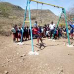 School had no playground equipment.  STF added two swing sets.  First time students had seen swings.